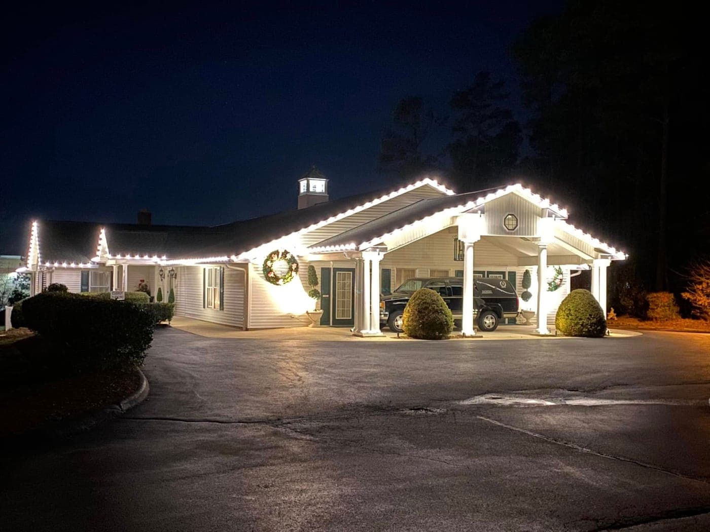 Commercial Christmas lights and lit wreaths on a Southern Maryland property