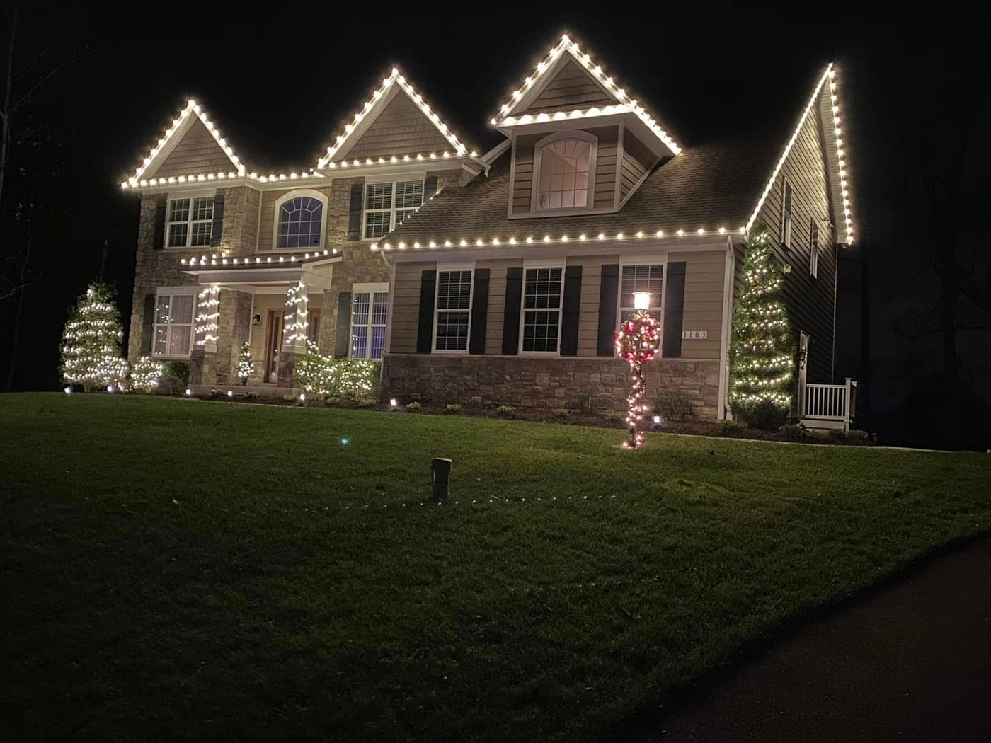 Custom Christmas lights, wrapped columns, and lit shrubs on a home in St. Mary’s County, MD